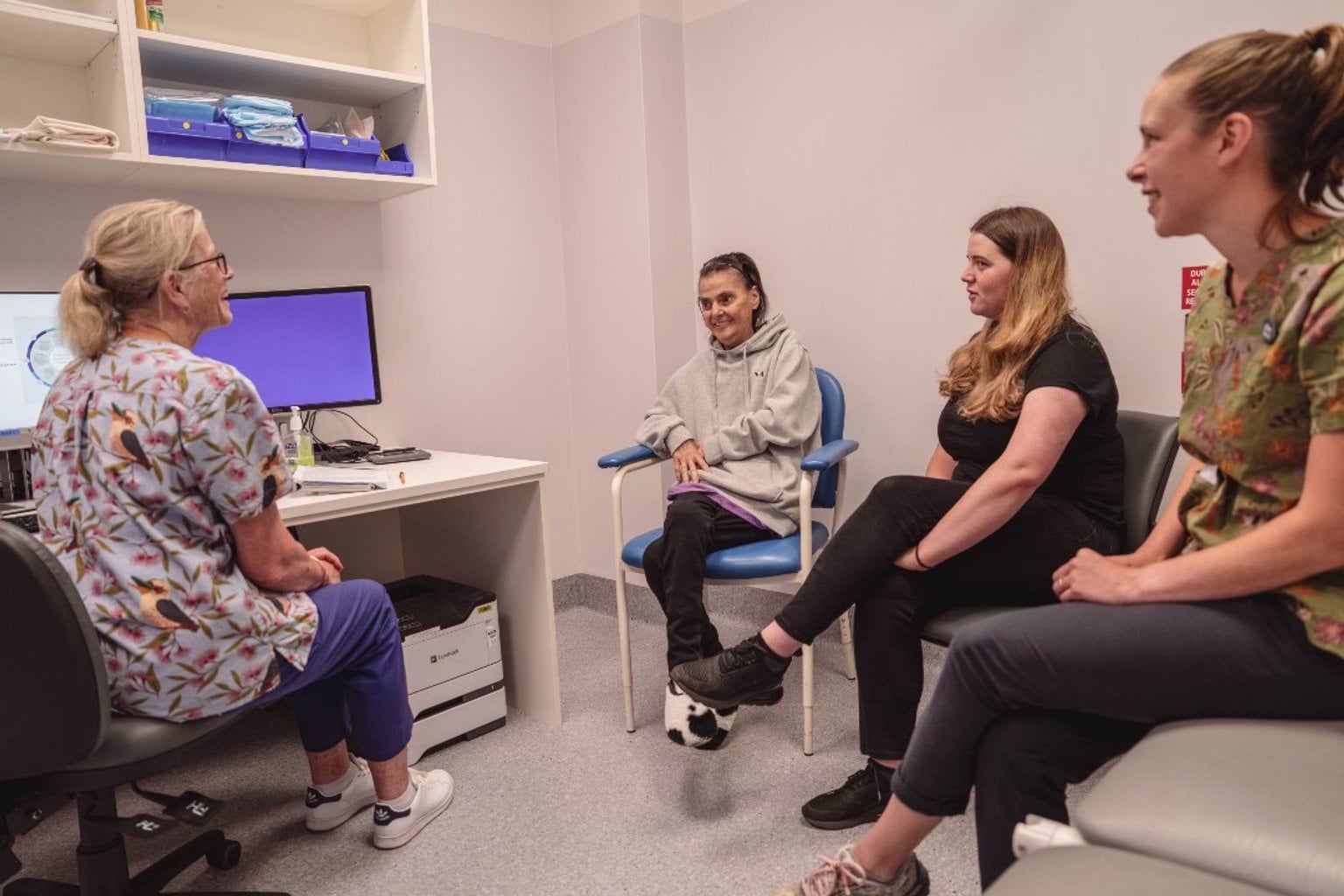 A GP talks to three patients