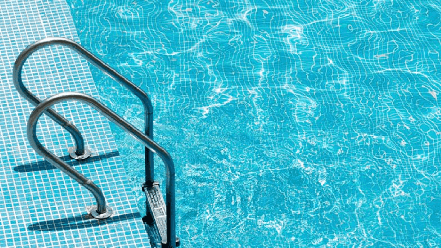 A close up image of swimming pool water in the sun